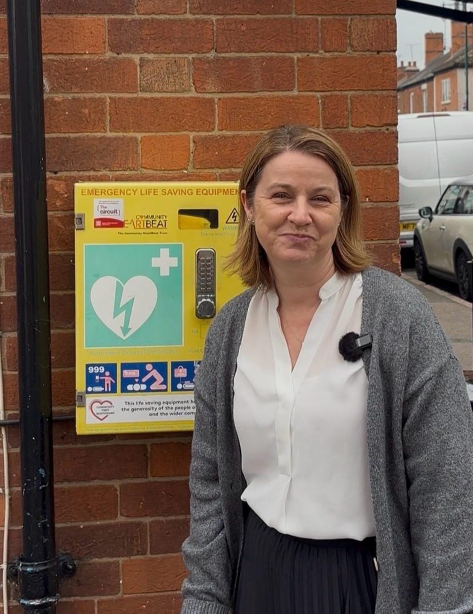 Amanda Hack MP stands by a defibrillator in Castle Donington